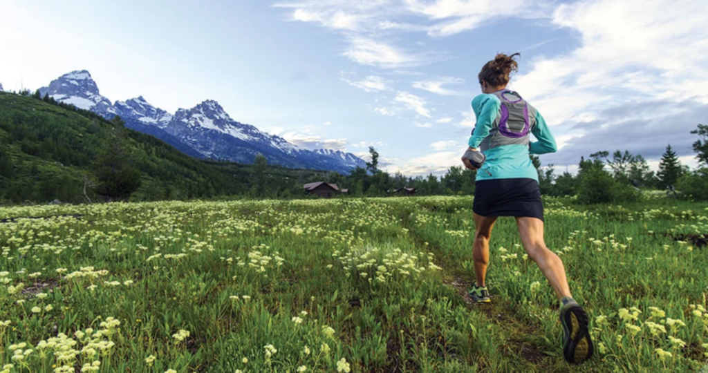 Get in shape for Nordic skiing - image of a female trail running