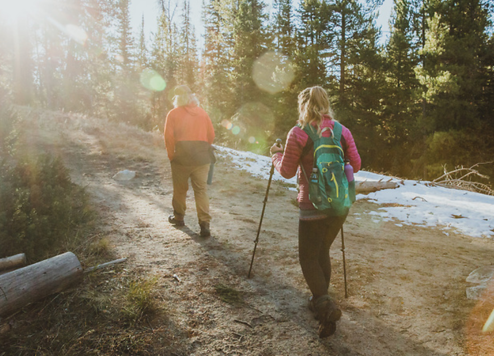 Image of two hikers walking up a trail