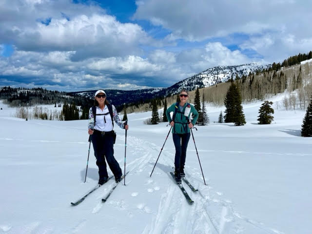 Explore More Winter - two skiiers pose for a picture in the Wyoming Wilderness