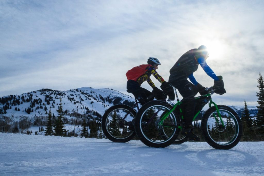 Fat Bike trails - Image of two people riding fatbikes in the afternoon light