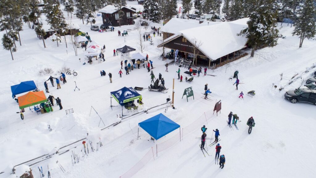 Thankful for the 5th Annual Free Ski, Fat Bike, & Snowshoe Day. Aerial image of event.
