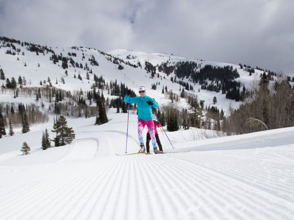 A skier in a bright outfit skate skis at Grand Targhee