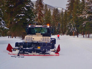 A PistenBully machine grooms the nordic ski track. 