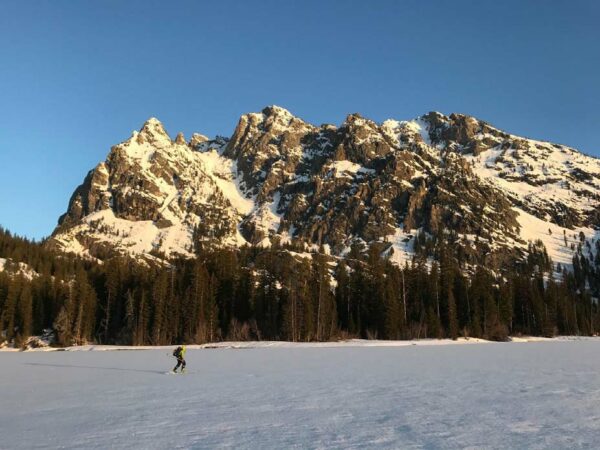 a cross country skier traverses Jenny Lake in GTNP 