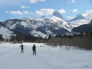 Nordic skiers outside with the Grand Teton in the distance 