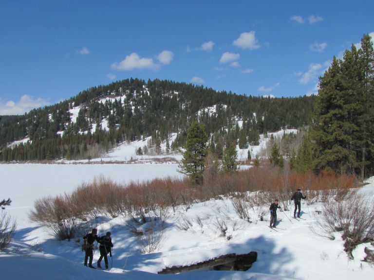 Skiers crossing a bridge at Two Ocean Lake