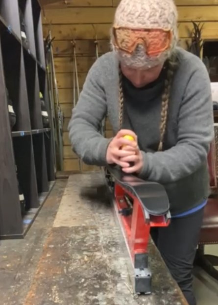 photo of woman waxing cross-country skis