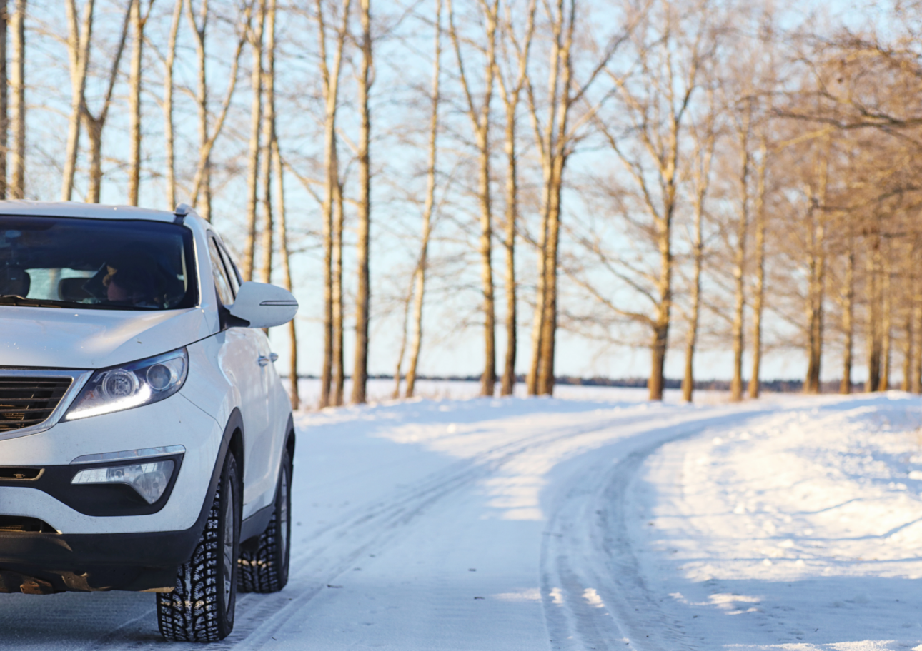 A white SUV on a snowy road