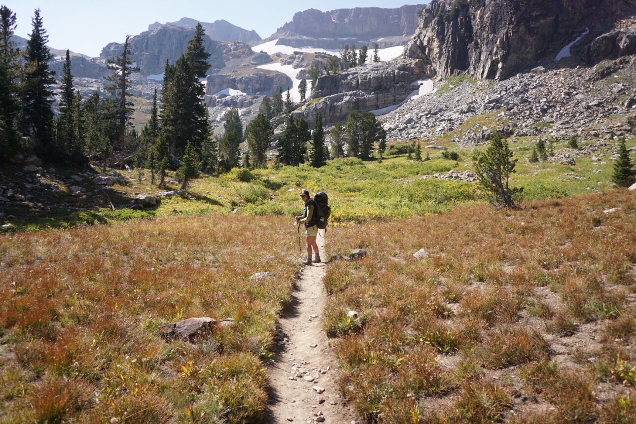 A hiker uses trekking poles on the Teton Crest Trail