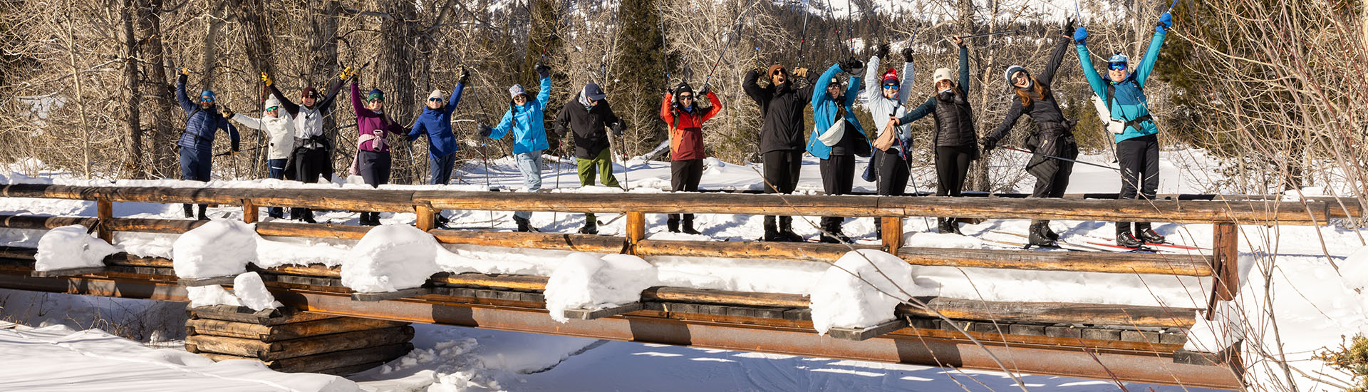 Nordic Alliance board members skiing on bridge