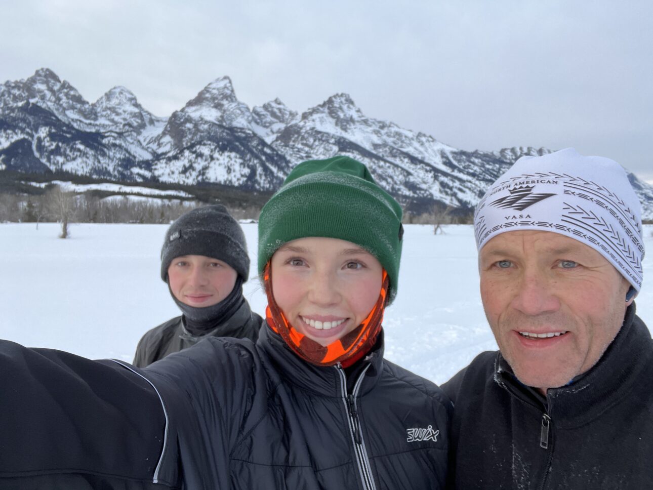 Bitzer family outside in winter in front of the Tetons