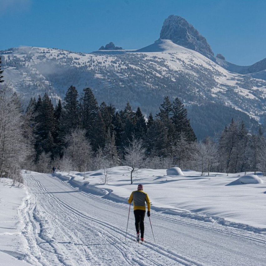 single classic skier heading out Teton Canyon, blue skies