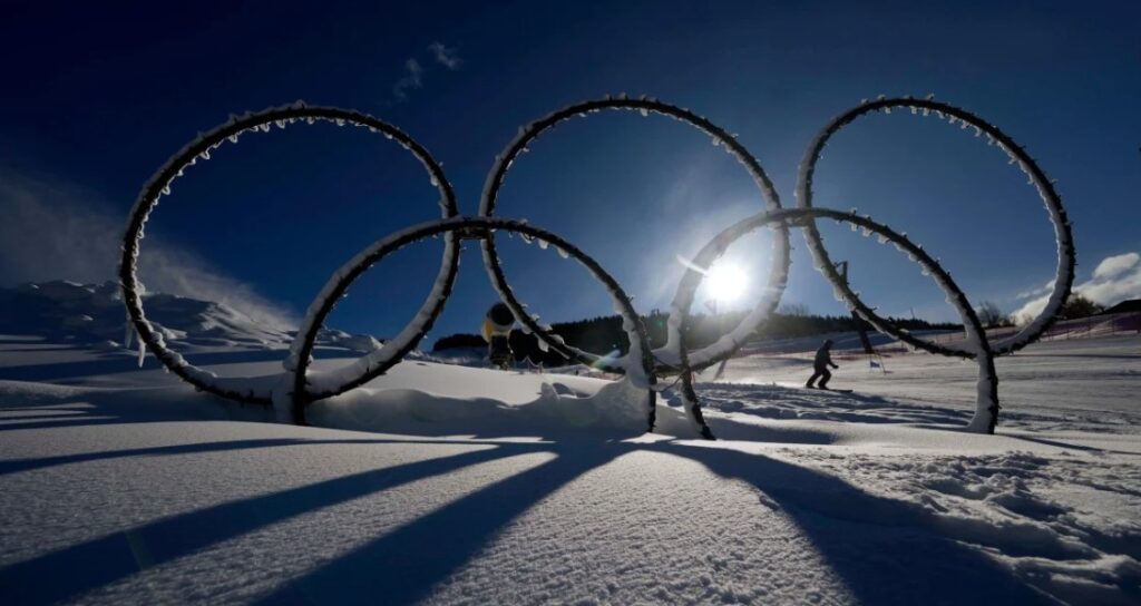 silhouette of Olympic rings and skier