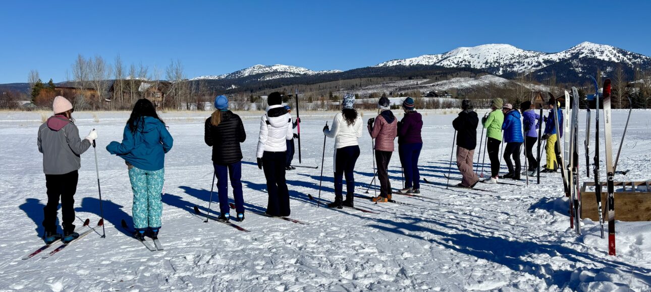 a line up of women at a ski clinic