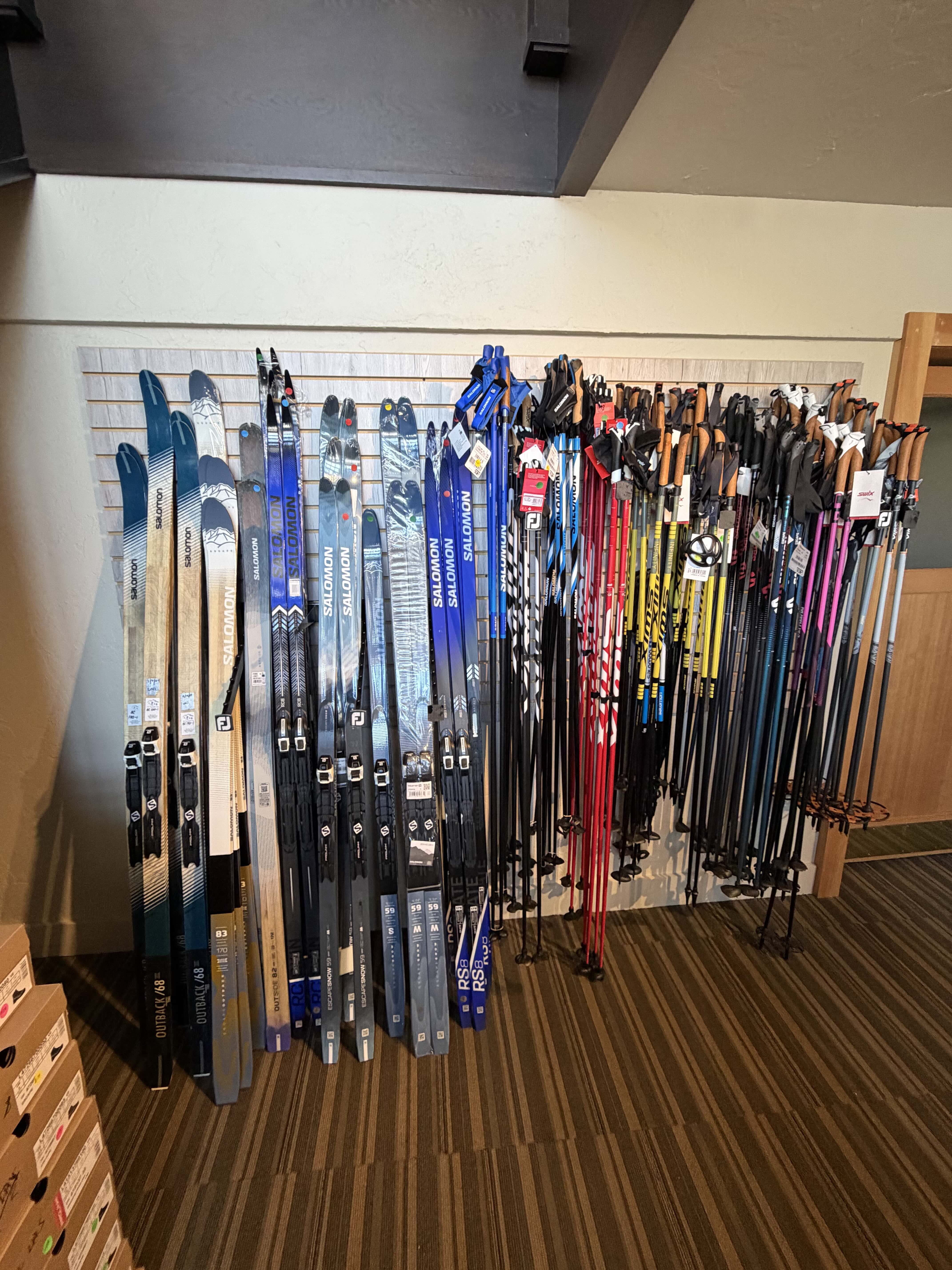 line up of skis and poles at the Pines sale area