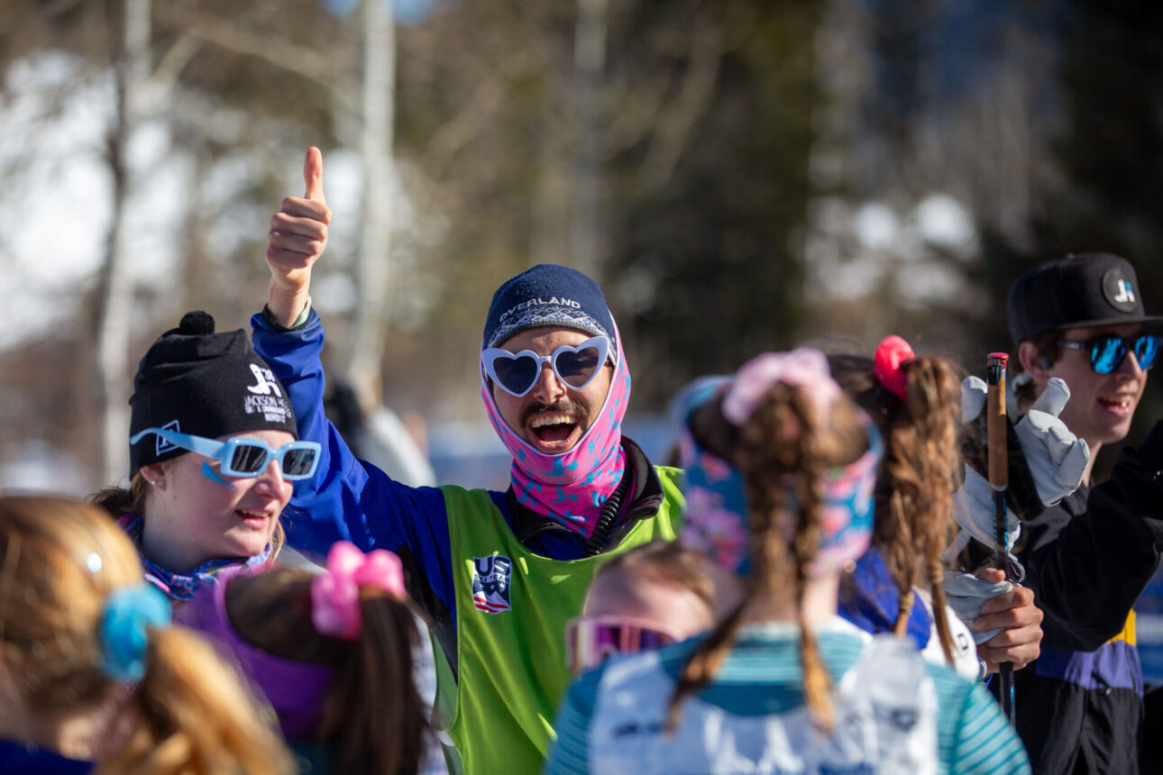 a nordic coach at a youth race - giving a big thumbs up